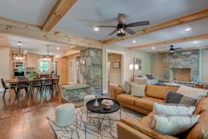 a living room with a couch and a stone fireplace at Orchard House in Banner Elk