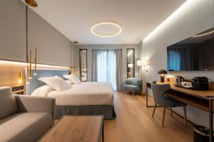 a hotel room with a bed and a desk at Hotel Mezquita Center in Córdoba +24 photos