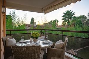 a table and chairs on a balcony with a view at Vivre Cannes l Parking l Balcony l 15min to La Croisette in Cannes