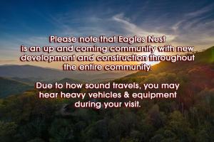 a sign that says please note that eagle nest is an up and coming community with at Moose's River Crossing at Eagles Nest in Banner Elk