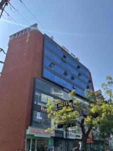 a tall building with a hotel sign in front of it at Hotel Shyam Inn in Vadodara