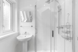 a white bathroom with a shower and a sink at Pass the Keys Modern 3Bed Garden Parking Nr Hainault Station in Chigwell +25 photos