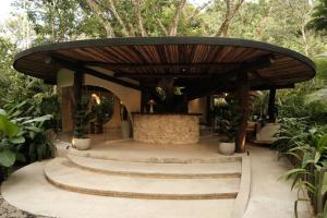a large wooden pavilion with stairs and trees at Isla Clara Hotel in San Francisco