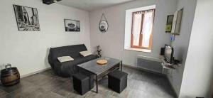 a living room with a couch and a table at Maison Puylaurentaise in Puylaurens