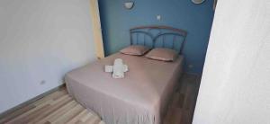 a bedroom with a bed with a cross on it at Maison Puylaurentaise in Puylaurens