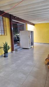 an empty room with a white refrigerator in a building at Hostel My House quartos perto do aeroporto de Guarulhos in Guarulhos