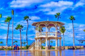 a gazebo in the water with palm trees at Hotel Miramar - La Paz in La Paz