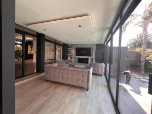 a living room with a couch and a dog at 2 on Aurora Island in Durbanville