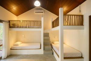 a bedroom with two bunk beds and a staircase at Jungle Trails in Sigiriya