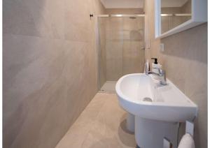 a bathroom with a white sink and a shower at Maison Vittoria in Ischia Town +15 photos