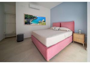 a bedroom with a bed and a painting on the wall at Maison Vittoria in Ischia Town