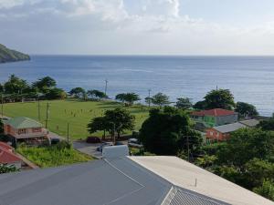 a view of a town with a field and the ocean at Villa Océane in Dublanc +10 photos