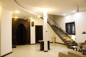a living room with a spiral staircase in a building at Arrow Villas in Meda-Ela