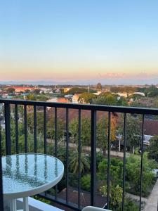 a balcony with a table and a view of the ocean at New great pool and gym condo chiangmai in Chiang Mai