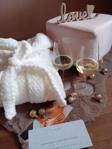 two glasses of white wine next to a box at Hotel u Budvaru in České Budějovice