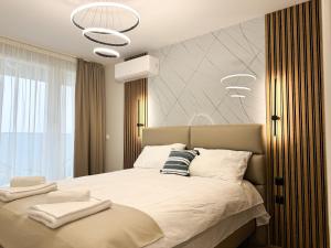 a bedroom with a large bed with white sheets at 2BР Apartment in a Modern Complex in Plovdiv