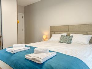 a bedroom with a bed with towels on it at 2BР Apartment in a Modern Complex in Plovdiv