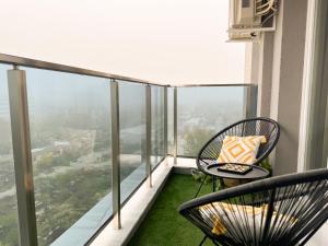 a balcony with a table and chairs on a balcony at 2BР Apartment in a Modern Complex in Plovdiv