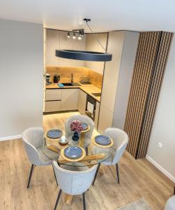 a kitchen and dining room with a table and chairs at 2BР Apartment in a Modern Complex in Plovdiv