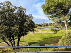 a view of a park from a balcony at Greens View golf saumane in Saumane-de-Vaucluse