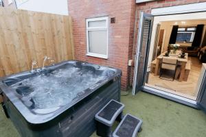 a hot tub in a yard next to a building at Marine Cottage 1 - With Private Hot Tub in Newbiggin-by-the-Sea