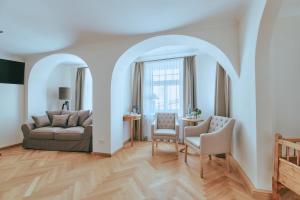 a living room with a couch and chairs and a table at Brauereigasthof zum Kuchlbauer in Abensberg +61 photos