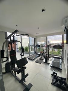 a gym with several treadmills and elliptical machines at Comfortable 2 Bed Apt Steps From Shopping Del Sol in Colonia Lomas Valentinas