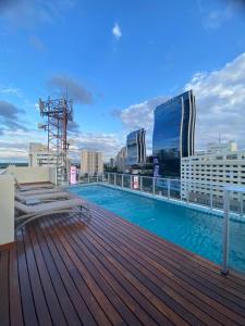 a swimming pool on the roof of a building at Comfortable 2 Bed Apt Steps From Shopping Del Sol in Colonia Lomas Valentinas