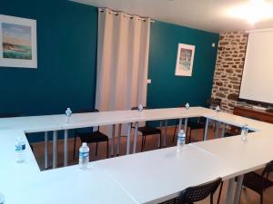 einen Tagungsraum mit Tischen, Stühlen und einem Bildschirm in der Unterkunft Gîte Les Hervelines in Le Val Hervelin