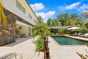 a swimming pool in front of a house at Croix Du Sud by Host Agents in Palmar
