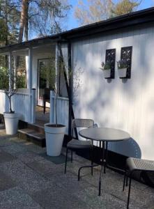 a patio with a table and chairs and a building at Celisa S Häuschen in Hoenderloo
