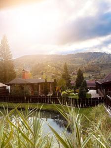 a house with a bridge over a body of water at Chalet Filvarok in Slavske