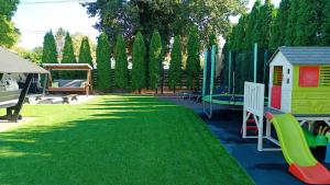 a yard with a playground with a play equipment at Eleven Apartman Agárd in Gárdony