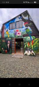 a building with a painting on the side of it at Finca de Descanso El Ocaso in Sevilla