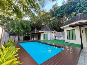 a swimming pool in the backyard of a house at Avare House Krabi in Ao Nam Mao