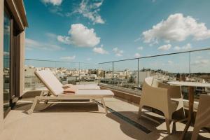 a balcony with a view of a city at Regional Hotel by NEU Collective in Il-Gżira