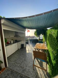 an outdoor patio with a table and a kitchen at Gönül Evim in Bogazici