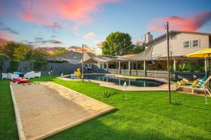 a backyard with a swimming pool and a house at Great home, great location at a great price! in San Antonio