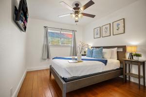 a bedroom with a bed with a ceiling fan at Great home, great location at a great price! in San Antonio +40 photos