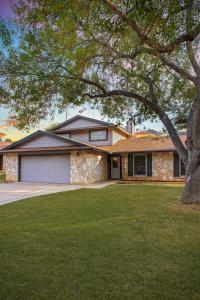 a brick house with a tree in the yard at Great home, great location at a great price! in San Antonio