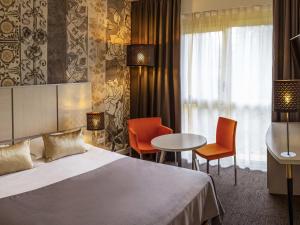 Postel nebo postele na pokoji v ubytování Mercure Bourg En Bresse