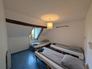 three beds in a room with a window at Crazy Villa Ricardière 89 - Indoor heated pool - Basket - 2h Paris - 30p in Villefranche-Saint-Phal +19 photos
