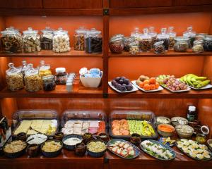 a shelf filled with lots of different types of food at Villa Admiral in Gdynia