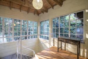 a room with a table and some windows at Pool House Studio by YourHost Karen Nairobi in Nairobi