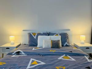a bedroom with a blue bed with two lamps at Modern & Cozy apartment in center -Walk everywhere in Sarajevo