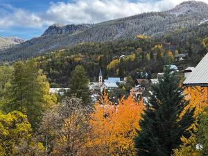 a small town in the mountains with autumn trees at Parc des Ecrins 05290 Les MAISONNETTES APPARTEMENT 4 Pers in Puy-Saint-Vincent