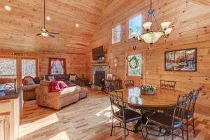 a dining room and living room in a log cabin at Hot-Tub Fire-Pit WineCountry Gym IndoorHeatedPool GasGrill in Ellijay