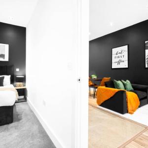 a living room with a bed and a couch at Cozy Apartment - Netflix - On Street Parking - Rowley Regis 49G in Halesowen