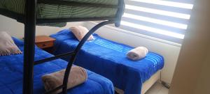 a bedroom with two bunk beds and a window at Costa Algarrobo Norte in Algarrobo +15 photos