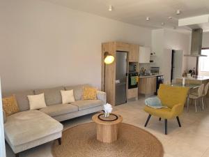 a living room with a couch and a table at Seaside Escape with Breathtaking View in Grand Gaube +18 photos